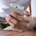 Image of cell phone in hand. Photo Credit: Copyright: sutichak / 123RF Stock Photo