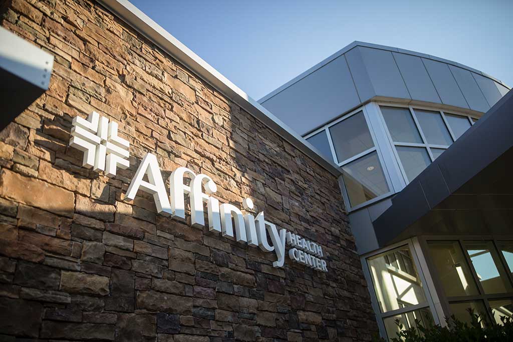 Affinity Health Center exterior features natural stone, steel and glass.